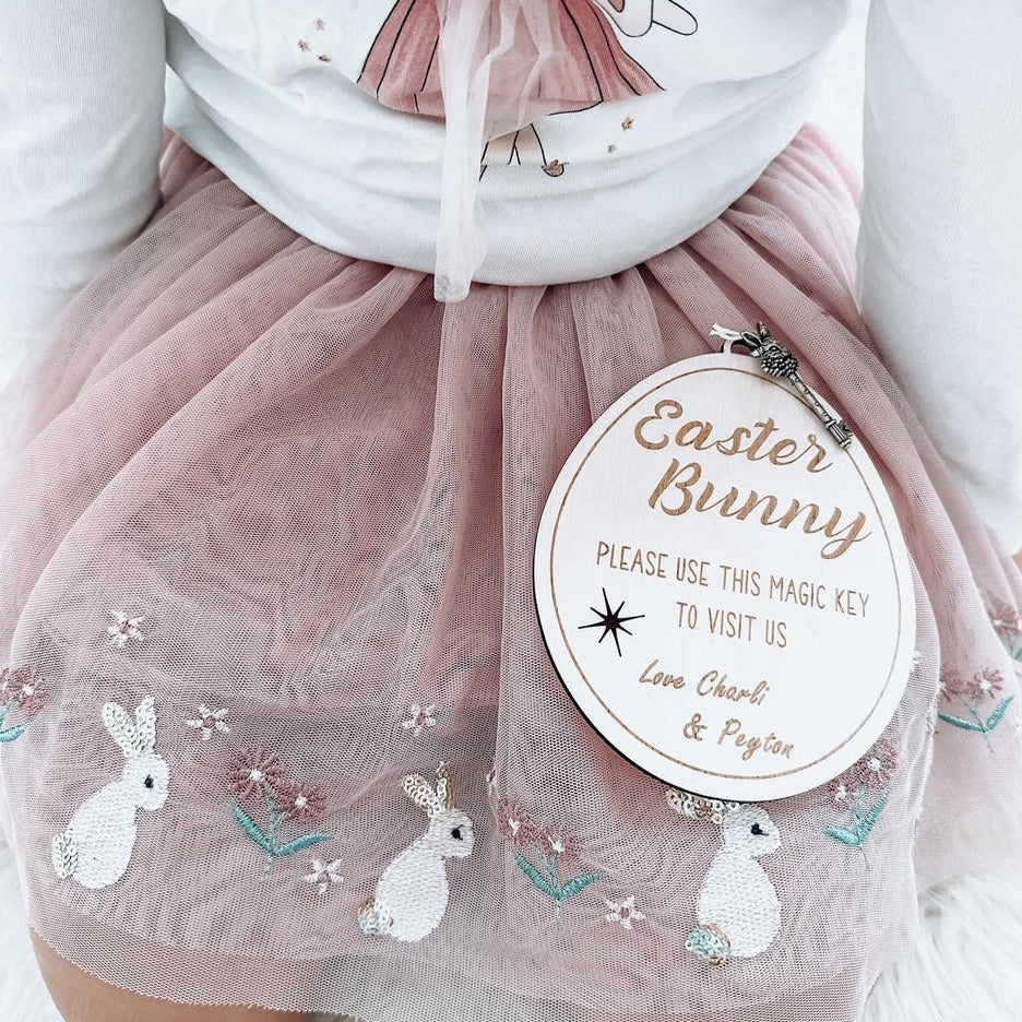 Easter Bunny Magical Key laying flat on the lap of a little girls easter skirt