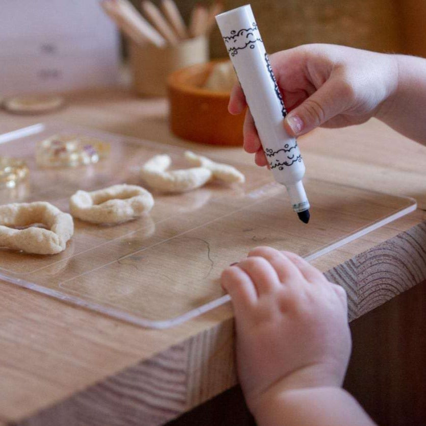 Learn With Me, child completing Write It section of the board