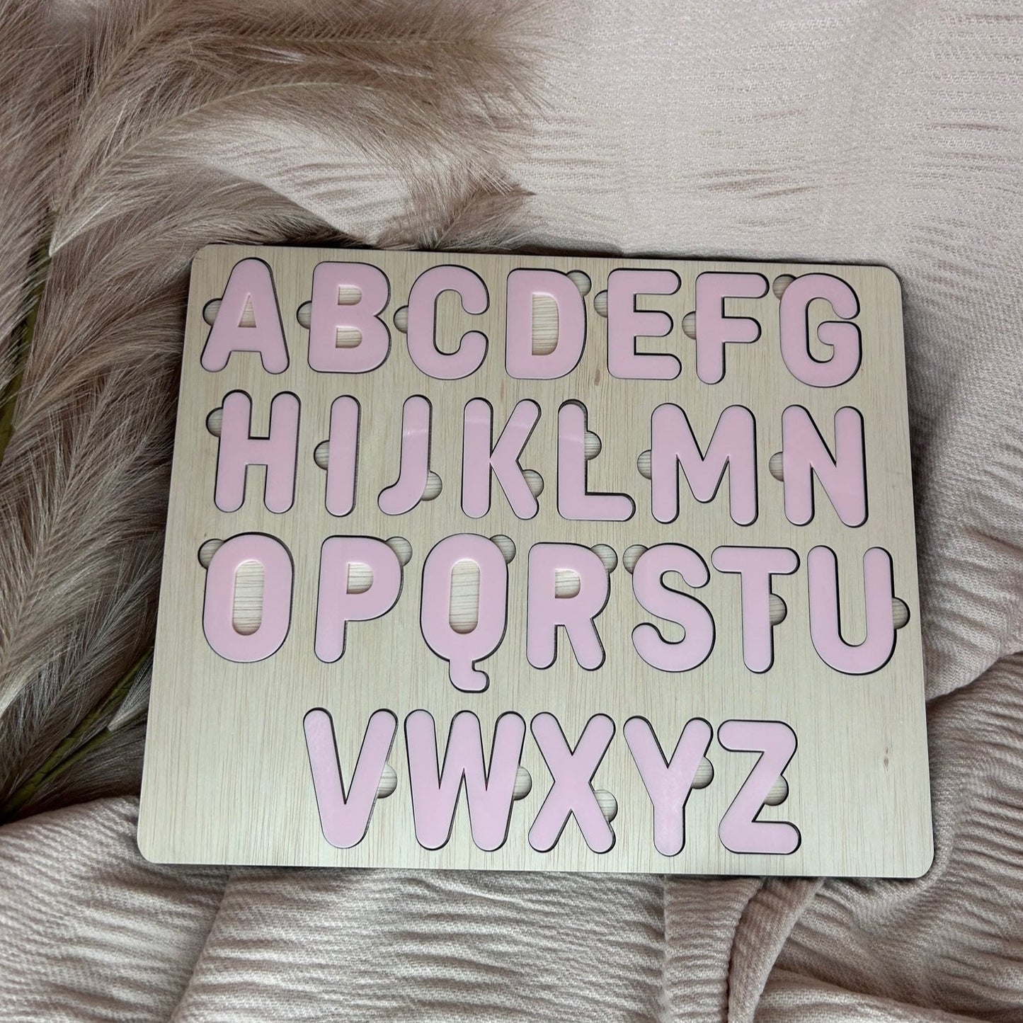 Alphabet Puzzle that is inspired by the Montessori Method of hands on approach to play.  Educational Toy at its finest.